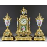 An Early 20th Century French Gilt Metal and Porcelain Mounted Three-Piece Clock Garniture, the clock