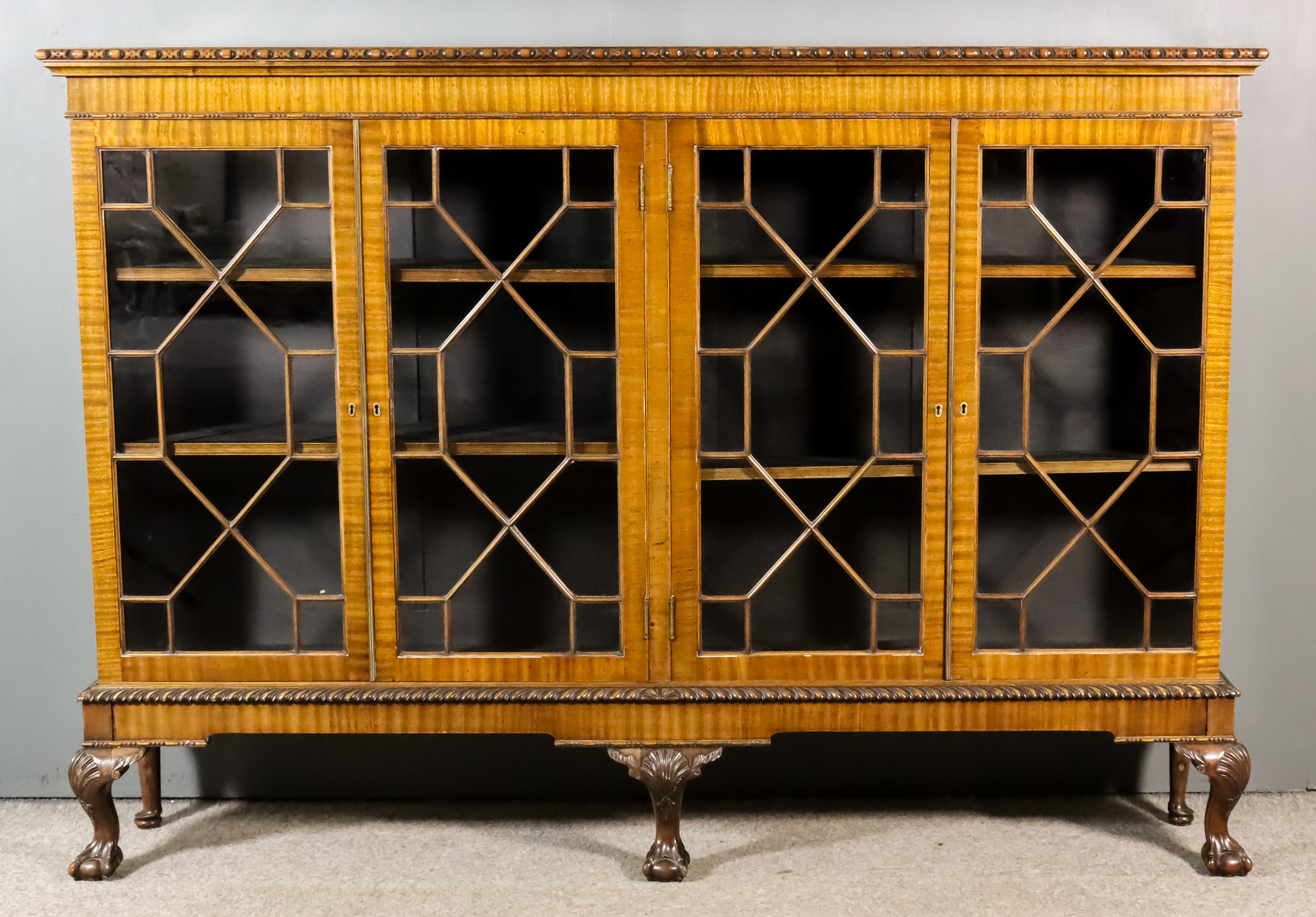 A 1920's Mahogany Dwarf Bookcase of "Chippendale" Design, with oval bead carved edge to top,