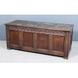 A 17th Century Panelled Oak Coffer, with four-panel lid, the front with moulded rails, frieze