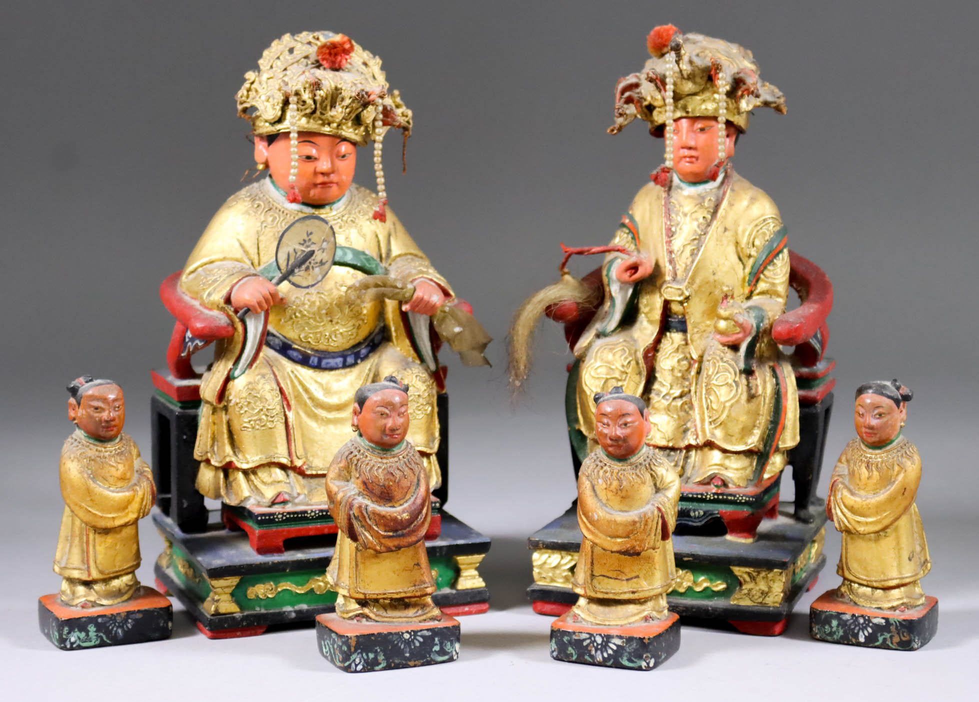 A Pair of Chinese Carved Polychrome and Gilt Wood Seated Figures of Female Goddesses Wearing