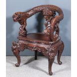 A Chinese Hardwood Tub Shaped Chair, the back boldly carved with a dragon and cloud motifs, the seat