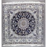 A Nain Carpet, Modern, woven in pastel colours with a bold central floral shaped medallion,