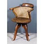 A Victorian Ash (?) and Elm Seated Tub Shaped Desk Chair, with shaped cresting and cane panel