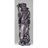 A Chinese Carved Hardwood Figure of a Sage, his robes inlaid with silver wire, 17.75ins (45.1cm)