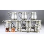 Eleven Pewter One Pint Tankards, with baluster shaped bodies and double scroll handles, 5ins high, a