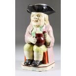 A Staffordshire Pearlware Toby Jug, Circa 1790-1800, of traditional form, seated and holding a jug