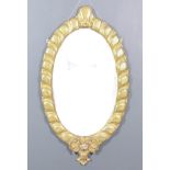 A Late 19th Century French Gilt Framed Oval Wall Mirror, with shaped C and leaf scroll cresting