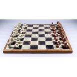 A Danish Stoneware Chess Set, and Rosewood and Stoneware Board, Circa 1960s, kings 3ins high,