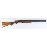 A 12 Bore Over and Under Shotgun, by Miroku, Serial No. 711550, the 28ins blued steel barrels with