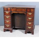 A George III Lady's Mahogany Kneehole Dressing Table, with moulded edge to top, fitted five small