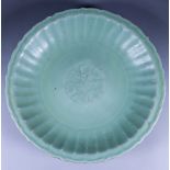 A Chinese Longquan Celadon Glazed Circular Bowl, Late Ming 16th Century, with slightly shaped rim