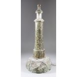 A Cornish Turned Serpentine Lighthouse Pattern Electric Table Lamp, on rocky base, 18.5ins high