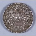 A George V 1928 "Wreath" Crown, good VF/EF with slight edge mark