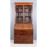 A George III Mahogany Bureau with Later Bookcase Top, the bookcase with moulded cornice, fitted