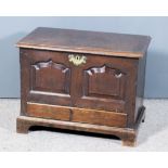 An 18th Century Welsh Oak Coffer Bach, the plain lid with moulded edges, the front with twin