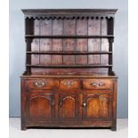 An 18th Century Panelled Oak Dresser, the upper part with moulded cornice and shaped frieze and