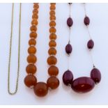 Two Amber Necklaces, Modern, one from reconstituted oval amber beads interspersed with gilt metal