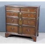 A 17th Century Oak Chest, with plain top and panelled sides, fitted two short and three long