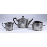 A Victorian Harlequin Silver Circular Three-Piece Tea Service, by Martin, Hall & Co, Sheffield