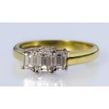 A Three Stone Diamond Ring, Modern, in 18ct gold mount, set with three baguette cut diamonds,