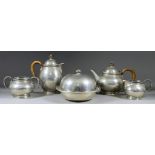 An Early 20th Century "Tudric" Hammered Pewter Four-Piece Tea Service, with circular bulbous bodies,