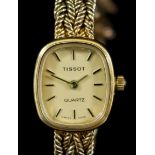 A Lady's Tissot 9ct Gold Quartz Wristwatch, the gold coloured dial with gold baton numerals, 20mm