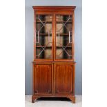 An Edwardian Mahogany Bookcase of "Georgian" Design, the whole inlaid with satinwood bandings and