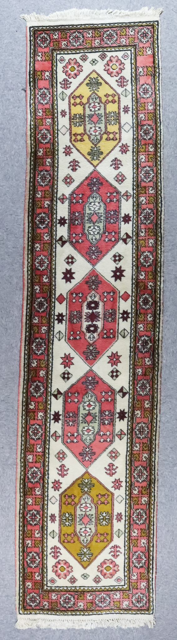 A Turkish Runner of "Kazak" Design, 20th Century, woven in pastel shades, with five lozenge shape - Image 2 of 2