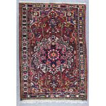 A Baktiari Rug, 20th Century, woven in colours, the central medallion of floral design with