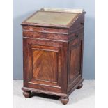 An Early 19th Century Panelled Mahogany Davenport, the pull-out top with brass gallery and bead