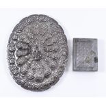 An Egyptian Silver Backed Oval Dressing Table Mirror and a Persian Silver Rectangular Box, the