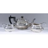 A Late Victorian Bachelors Silver Oval Three-Piece Tea Service, by Charles Boyton, London 1895, with
