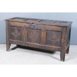 A 17th Century Panelled Oak Coffer, with moulded rails and four-panel lid, the three-panel front