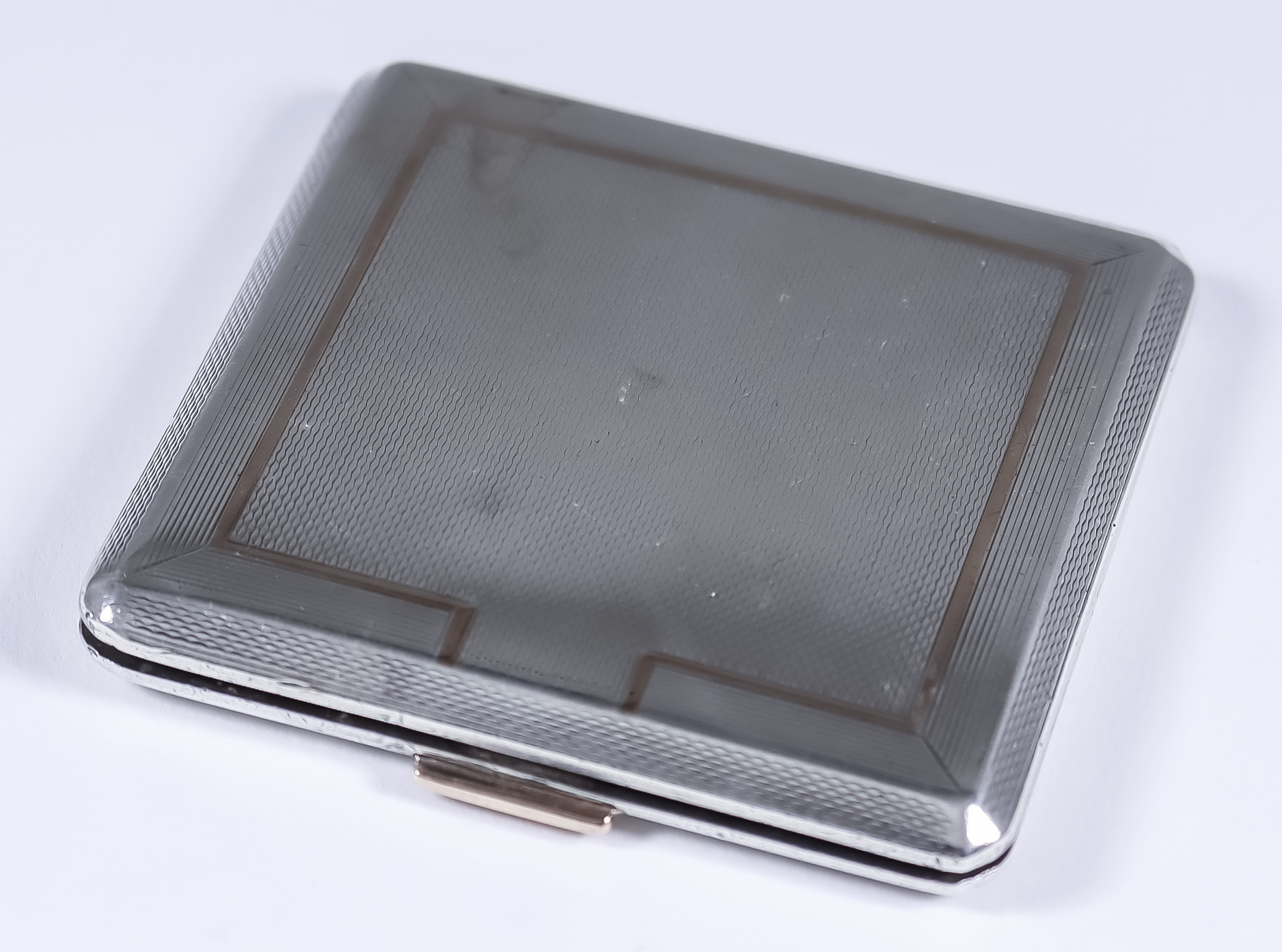 An Edward VIII Silver Square Compact, by Mappin & Webb, London 1936, with engine turned ornament,