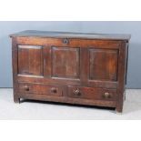 An 18th Century Panelled Oak Mule Chest, the plain lid with moulded edge, the front with three