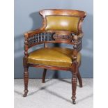 A Late Victorian Walnut Framed Tub Shaped Library Armchair, the shaped crest rail above