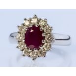 A Ruby and Diamond Ring, Modern, in 18ct white gold mount, the centre set with a ruby, approximate