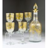 A 19th Century Dutch Gilt Decorated Decanter and Five Matching Glasses, the decanter with faceted