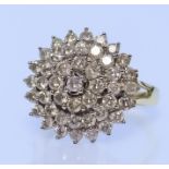 A Diamond Cluster Ring, Modern, in 18ct gold mount, set with round brilliant cut white diamonds,