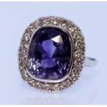 A Sapphire and Diamond Ring, Modern, in platinum mount, set with a central cushion cut natural Sri