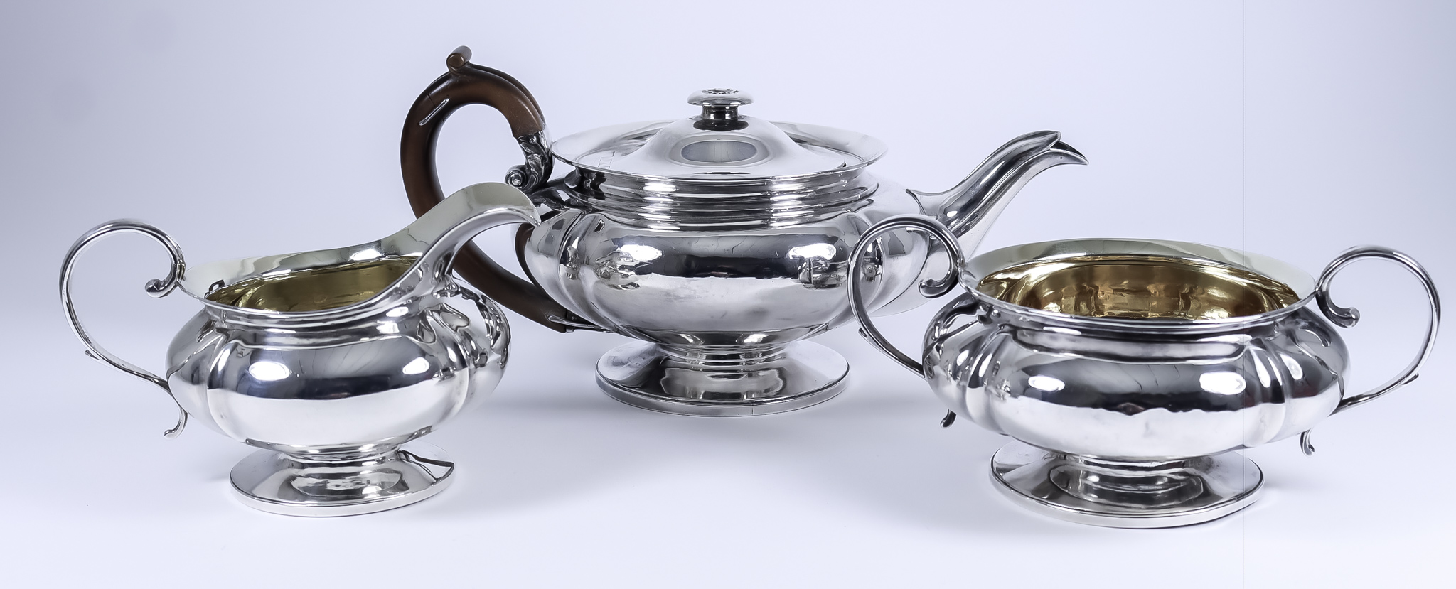 A George IV Silver Circular Three-Piece Tea Service, by William Eley & Charles Price, London 1827,