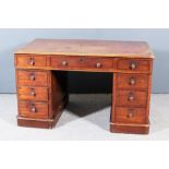 A Victorian Mahogany Kneehole Desk, the top inset with tooled leather, with moulded edges and