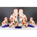 Seven Staffordshire Pottery Dogs, Circa 1860, including - rare model with puppies in a basket, 5.