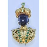 A Gilt Metal and Emerald Blackamoor Brooch, by Vesco, set with fourteen small emeralds and one