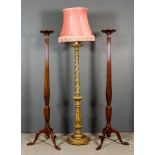 A Pair of Mahogany Tray Top Torcheres, the reeded columns with carved swag ornament, on tripod