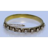 A 14ct Gold Pearl and Diamond Stiff Bracelet, 20th Century, set with nine cultured pearls, each
