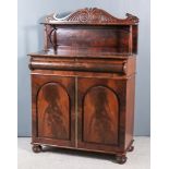 An Early Victorian Mahogany Chiffonier, the upper part with carved twin scroll cresting above