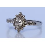 A Diamond Cluster Ring, Modern, in 18ct white gold mount, set with a centre marquise cut diamond,