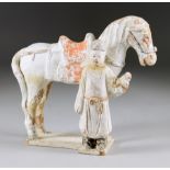 A Chinese Painted Terracotta Equestrian Tomb Figure, Ming, of a horse with standing figure to front,