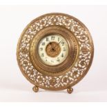 LATE VICTORIAN PIERCED BRASS CIRCULAR STRUT CLOCK with pierced foliate scroll border, two part